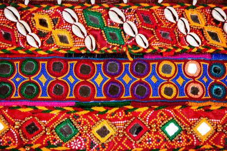 Colorful ethnic belts with mirrors and shells at market in Rajasthan, India