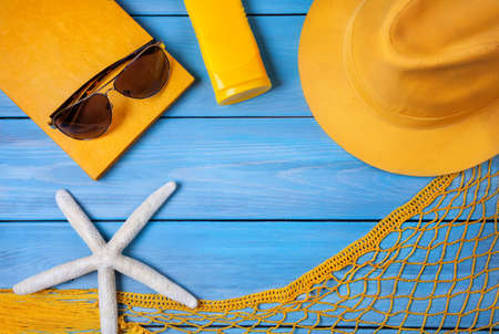 Summer holiday stuff on blue wooden backgroundの写真素材