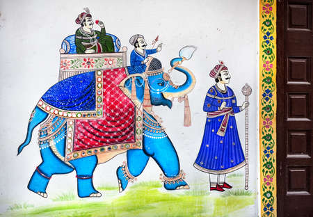 Traditional Rajasthan painting on the house wall of king riding on the blue elephant in Udaipur,...