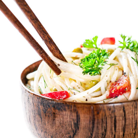 Chopsticks with Vegetarian noodles on white backgroundの写真素材