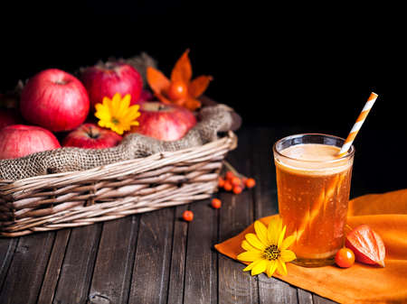 Fresh apple juice on wooden background in autumn seasonの写真素材