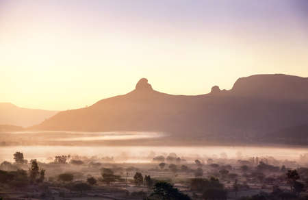 Foggy mountain valley at sunrise in the village in Nasik, Maharashtra, India