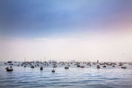 Boats in Mumbai Harbor at blue sky, Maharashtra, Indiaの写真素材