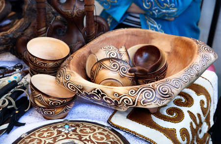 Ethnic wooden cup and bowls with oriental pattern and souvenirs in the market at Nauryz celebration in Almaty, Kazakhstanの写真素材