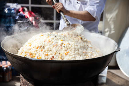 Big pot with Plov national Kazakh food on the street of Almaty during Nauryz festival in Kazakhstanの写真素材