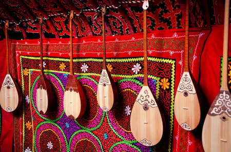 Dombra string instruments on the wall of Kazakh yurt at Nauryz celebration in Almaty, Kazakhstanの写真素材