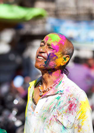 Udaipur, India - March 6, 2015: Portrait of Indian man with painted face celebrating the colorful festival of Holi on the street.のeditorial素材