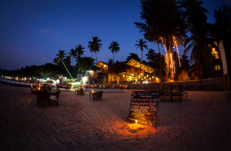 Romantic beach with restaurant and menu with candle lighting at night at Palolem in Goa, Indiaの写真素材