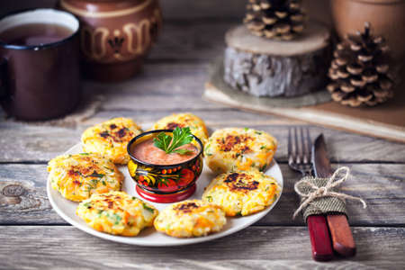 Russian vegan cutlets from potato and rice served with spicy tomato sauce in hohloma bowl on Shrovetide holidaysの写真素材