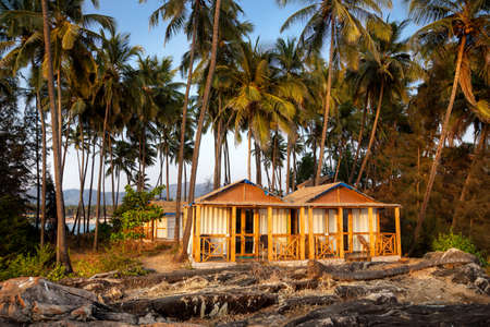 Tropical hotel on the beach with balcony and palm trees in Goa, Indiaの写真素材