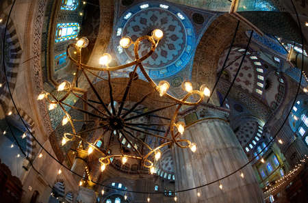 Glowing chandelier and Interior of the Blue Mosque, Istanbul. Turkey