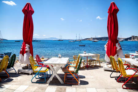 Colorful chairs and white table in seaside restaurant in Bodrum, Turkey