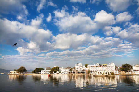 Lake Pichola with City Palace view at cloudy sky in Udaipur, Rajasthan, Indiaの写真素材