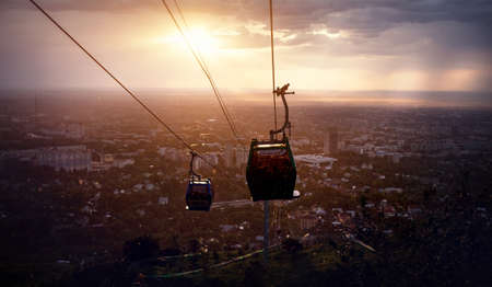 Silhouette of cable car at city view at dramatic stormy sunset sky backgroundの写真素材