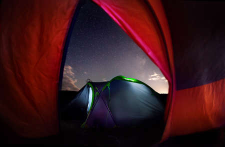 Tent camping tent in the forest with starry night skyの写真素材