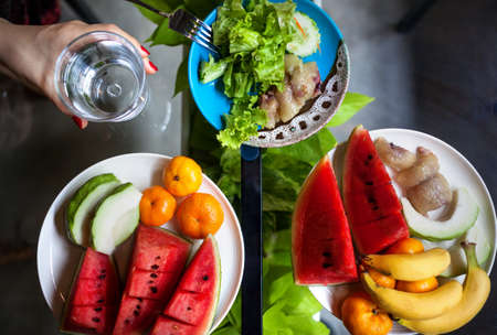 Plate with watermelon, banana, oranges and salad in restaurant in Thailand