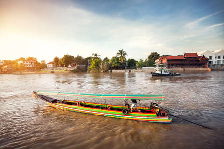 Longtail boat cruise by Chao Phraya river in Ancient city Ayutthaya, Thailandの写真素材