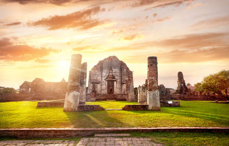 Ancient ruined facade and column of Temple in Lopburi at sunset sky, Thailandの写真素材