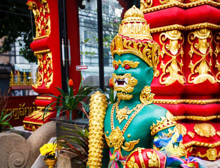 Buddhist temple with statue of guardian column with golden ornament in Chiang Rai, Thailandの写真素材
