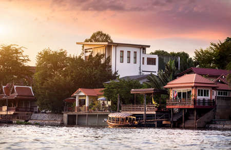 Tourist long-tail boat at river Chao Phraya in Ancient city Ayutthaya at Sunset in Thailandの写真素材