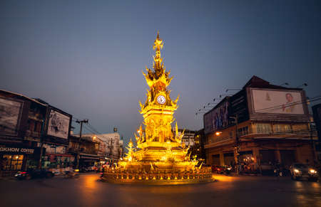 CHIANG RAI, Thailand - November 25, 2016: Golden clock tower with illumination, established in 2008 by Thai visual artist Chalermchai Kositpipatat at night.のeditorial素材