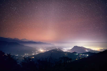 Lights of Pokhara city and villages at night starry sky at mountain range of Annapurna, Nepalの写真素材