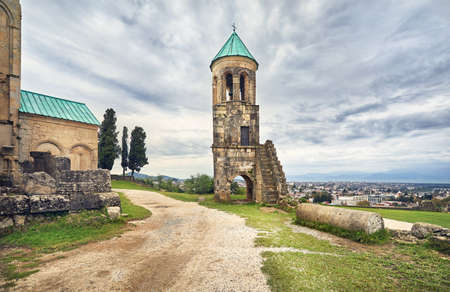 Bell Tower in front of Bagrati church at overcast sky in Kutaisi, Georgiaの写真素材