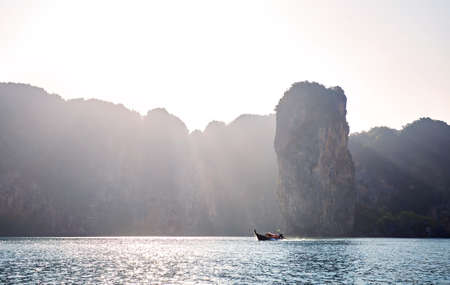Long tail boat at tropical islands at sunrise in Andaman sea, Thailandの写真素材