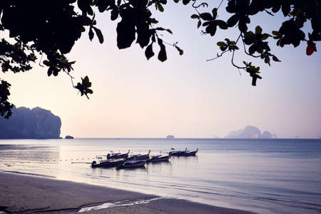 Traditional long tail on the tropical beach at morning in Andaman Sea, Thailandの写真素材