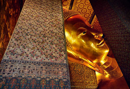 Famous Statue of Big Golden Buddha in wat Pho temple in Bangkok, Thailand. Symbol of Buddhist...