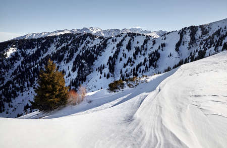 High mountains with snow and high peaks at winter timeの写真素材