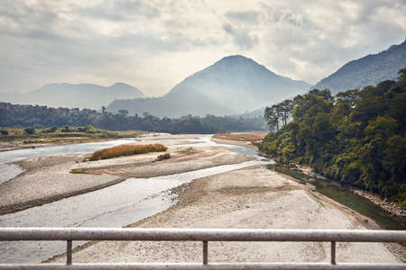Foggy Mountains and river at Himalayas near Pokhara in Nepal