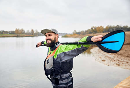 Portrait of bearded man in wetsuit on the beach