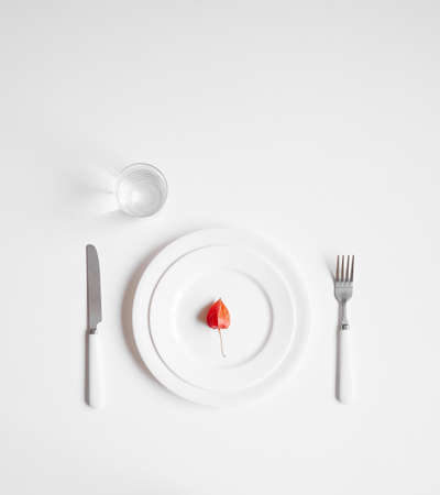 small gooseberry on the white plate and white table in minimalism styleの写真素材