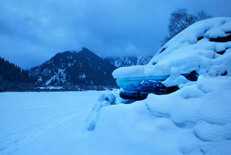 Landscape of frozen mountain lake Issyk with big ice formations at winter time in Kazakhstanの写真素材