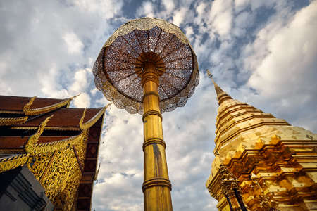 Golden Stupa in Buddhist Temple Doi Suthep at blue cloudy sky in Chiang Mai, Thailandの写真素材