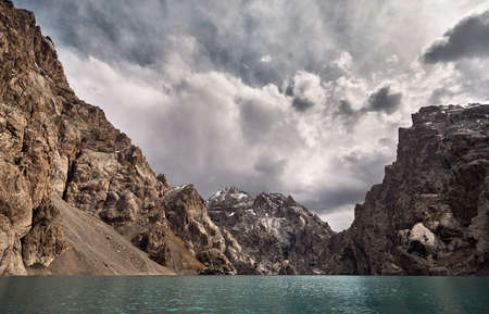 Beautiful landscape of famous mountain Lake Kel Suu at overcast cloudy sky, Naryn area, Kyrgyzstanの写真素材