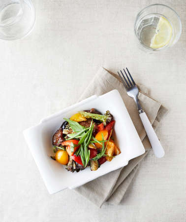 Vegetarian salad with fresh greenery, capsicum, tomato and fried eggplants top viewの写真素材
