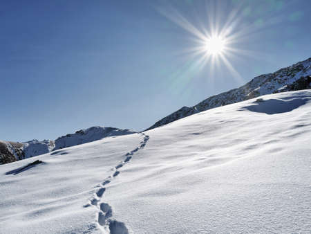 Beautiful Minimalism landscape at high mountains with snow against blue sky at winter time in Kazakhstanの写真素材