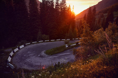 Asphalt road serpentine turn in the mountains in Kazakhstan at sunset sky. Famous mountain road to...