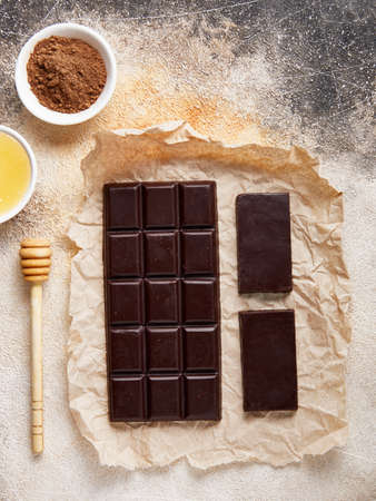 Healthy Sugar free Homemade dark chocolate with cocoa and honey on craft paper. Big and small barsの写真素材