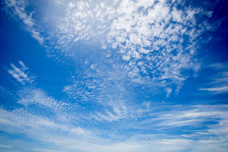 Blue sky background with tiny clouds