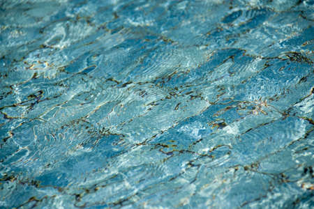 Hotel swimming pool with sunny reflectionsの写真素材