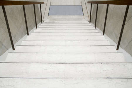 Modern white stairs with wooden handrail