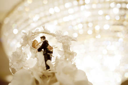 Miniature wedding doll with chandelier backgroundの写真素材