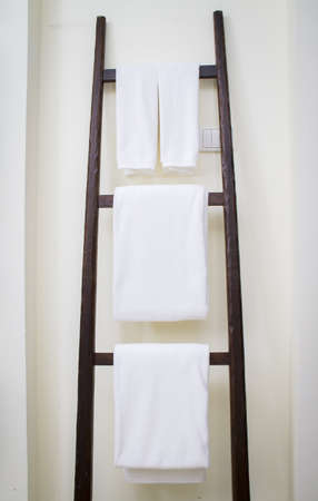 White spa towel hanging on wooden standの写真素材