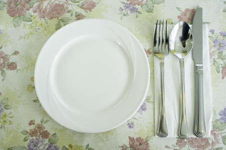 Dish, spoon, knife and fork on lovely tablecloth