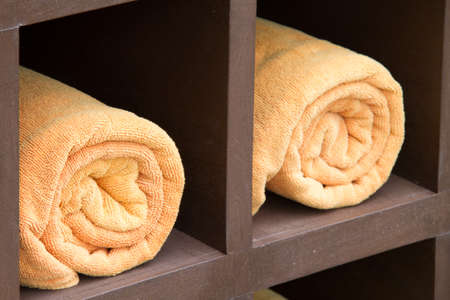 Rolled up orange spa towelsの写真素材