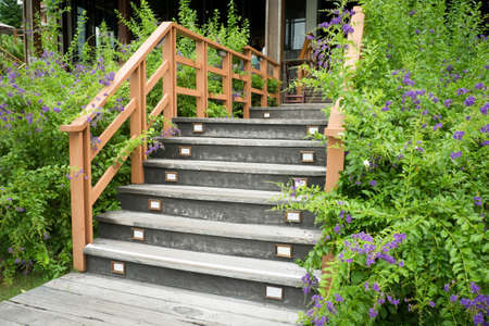 Stairs with wooden handrail in gardenの写真素材