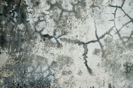 Broken concrete wall with cracks
